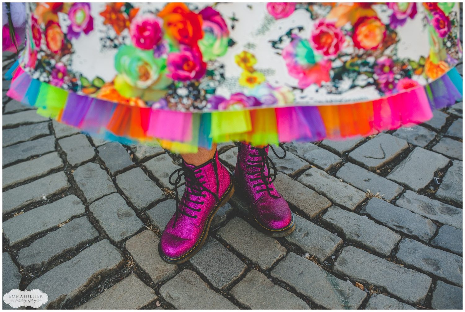 Bride wearing a rainbow dress and pink Dr. Marten boots