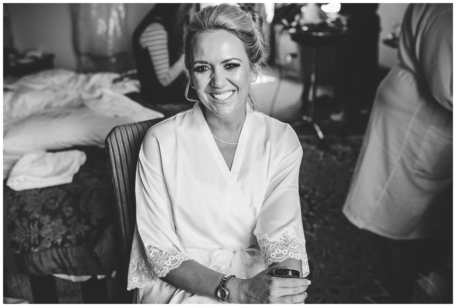 Smiling bride getting ready for her wedding at Peckforton Castle