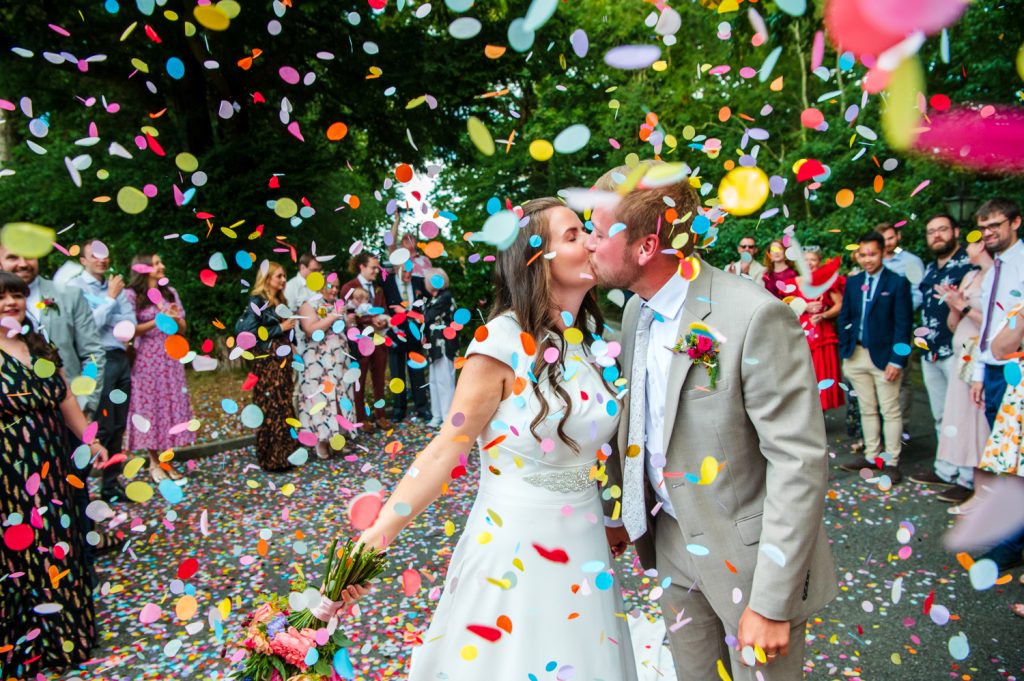 Liverpool wedding photographer colourful confetti being thrown at a couple
